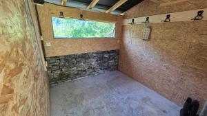 a room with a shower with a window in it at La cabane du pédaleur in Fourbanne +12 photos