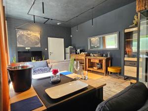 a living room with a couch and a table at L Escale Spa Privatif in Tournai