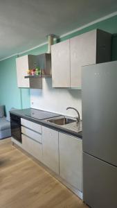 a kitchen with white cabinets and a sink at Casa Bella Vista in La Spezia +11 photos