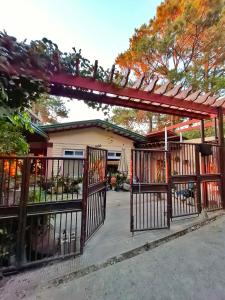 a gate in front of a house at Odara Pines Garden The Ridge House 1BR in Baguio