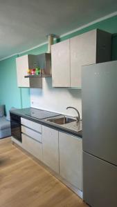 a kitchen with white cabinets and a sink at Casa Bella Vista in La Spezia