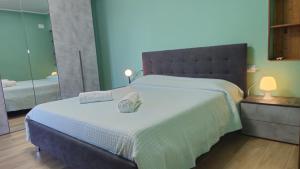 a bedroom with a large bed with two towels on it at Casa Bella Vista in La Spezia