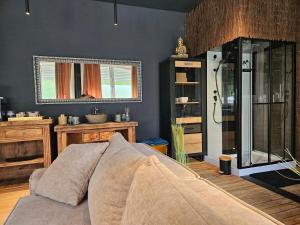 a bedroom with a bed and a shower in it at L Escale Spa Privatif in Tournai