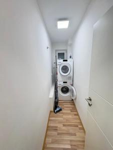 a washer and dryer in a small room at Private Apartment centrally located in Grafenwöhr +1 photo