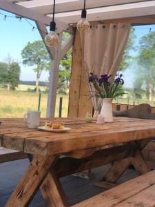 a wooden table with a plate of food on it at Chatka u Radka in Radacz