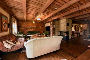 a living room with two couches and a fireplace at Saunaga suur puhkemaja Uneallikal, Harjumaal, kuni 11 inimest in Pae