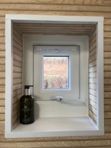 a bottle of wine in a window in a room at Olive Mae - Cosy Room with private en-suite bathroom in Blackwood +19 photos
