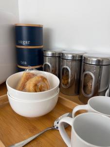 a bowl of food sitting on a table next to canisters at Olive Mae - Cosy Room with private en-suite bathroom in Blackwood