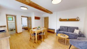 a living room with a couch and a table at Apartmány Nová Oleška in Huntířov