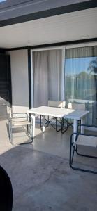 a white table and chairs on a balcony at El Contenedor Premium in San Francisco