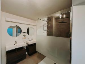 a bathroom with two sinks and a shower at Chez Dubuiss in Houffalize