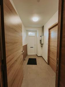 a hallway with a door and a door mat at Chez Dubuiss in Houffalize