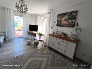 a living room with a tv and a table and a tvictericter at Sielskie Markowskie in Markowskie