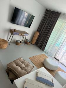 a living room with a flat screen tv and a couch at Aura Sun Villa in Agios Romanos