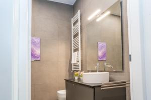 a bathroom with a sink and a mirror at Due Strade APT - Oltrarno Collection in Florence +23 photos