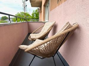 two wicker chairs sitting on a balcony at Apartman Stankovic in Negotin