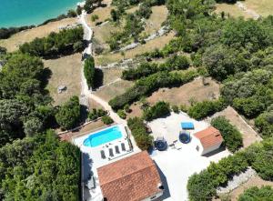 an aerial view of a house with a swimming pool at Beachfront Villa with Swimming Pool, Terrace and Sea view in Ston