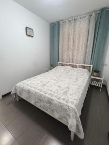 a bedroom with a bed with a white blanket and a window at Garden City apartment Costa Adeje in Costa de Adeje +10 photos