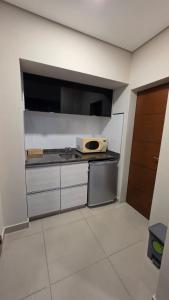 a kitchen with a counter top with a microwave at TORRE GUAYASAMIN in Corrientes