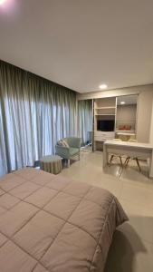 a bedroom with a large bed and a living room at TORRE GUAYASAMIN in Corrientes