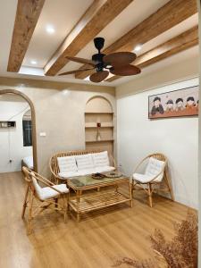 a living room with a couch and two chairs at Yuzu Home Hang Voi in Hanoi