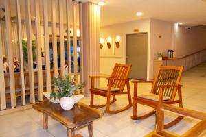 a living room with three chairs and a table at Hotel Rodadero Beach Blue in Santa Marta