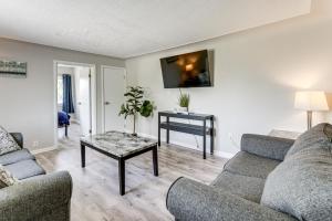 a living room with two couches and a table at Lake Huron Launchpad! Creekfront Condo for Two in Port Huron