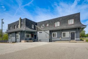 a gray house with a gambrel roof at Lake Huron Launchpad! Creekfront Condo for Two in Port Huron