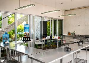 a kitchen with stainless steel tables and windows at Villa Merida Luxury Mansion - Adults Only Boutique Hotel in Mérida
