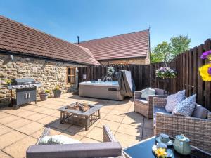 a patio with a tub and chairs and a table at 2 Bed in Bishop Auckland oc-94321 in Wolsingham