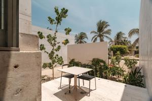 a table and two chairs sitting on a balcony at Casa Talá by Lumina in Puerto Escondido