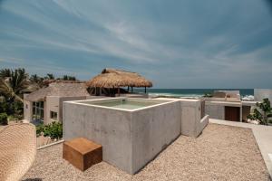 a resort with a swimming pool on the beach at Casa Talá by Lumina in Puerto Escondido