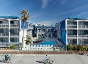two people riding bikes in front of a building at The Wayfarer San Diego in San Diego