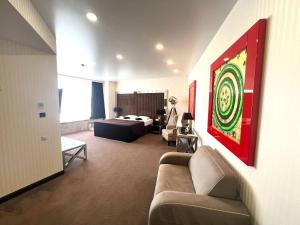 a living room with a couch and a bed at Apart Maristella sea view in Odesa