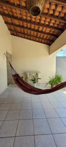 a hammock hanging from a ceiling in a room at Casa grande com suite in São Luís