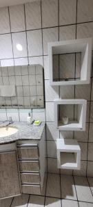 a bathroom with a sink and a mirror at Casa grande com suite in São Luís +15 photos