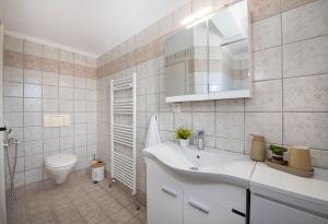 a bathroom with a white sink and a toilet at Fiore Marino in Kamisianá +56 photos