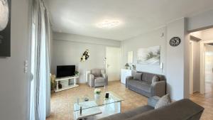 a living room with a couch and a table at Keremidis Apartment in Flogita