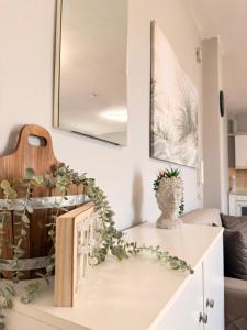 a living room with a table with a vase on it at Keremidis Apartment in Flogita
