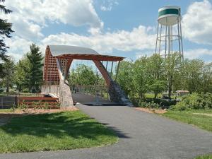 a wooden bridge with a water tower in the background at Guest Suite in Smiths Falls +11 photos