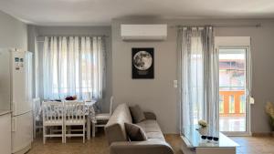 a living room with a couch and a table at Keremidis Apartment in Flogita