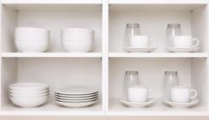 a shelf filled with dishes and cups and plates at Milestone Terrace - Premium Apartment near Airport & Super U in Antananarivo
