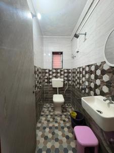 a bathroom with a toilet and a sink at ROGHAY COTTAGE in Matheran +44 photos