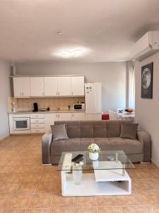 a living room with a couch and a table at Keremidis Apartment in Flogita +18 photos