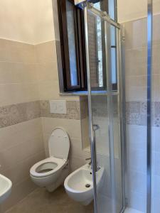 a bathroom with a toilet and a sink and a shower at Affittacamere Point Concept Rooms in Laurito +10 photos