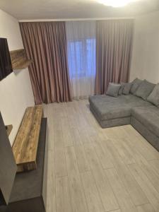 a living room with a couch and a table at ArtStay Apartment in Drobeta-Turnu Severin