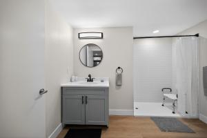 a bathroom with a sink and a shower with a mirror at Sleek 2BR apartment in prime location in Reading +12 photos