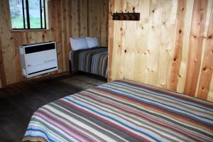 a bedroom with a bed in a wooden room at Drakesbad Guest Ranch in Chester