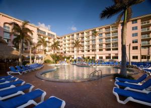 a resort with chairs and a swimming pool and a hotel at Palm Beach Shores Resort and Vacation Villas in Palm Beach Shores