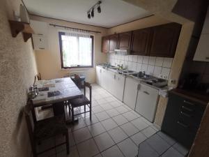a small kitchen with a table and a counter top at Guest House Dijana in Kraljevica